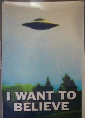 Poster with a photograph of a flying saucer, with the text "I WANT TO BELIEVE" underneath it. This is the original version of this famous poster, shown in the first three seasons of The X-Files, prior to photographer/artist/ufo-cult-founder Billy Meier's copyright complaint which caused it to be replaced with different photographs in later seasons.